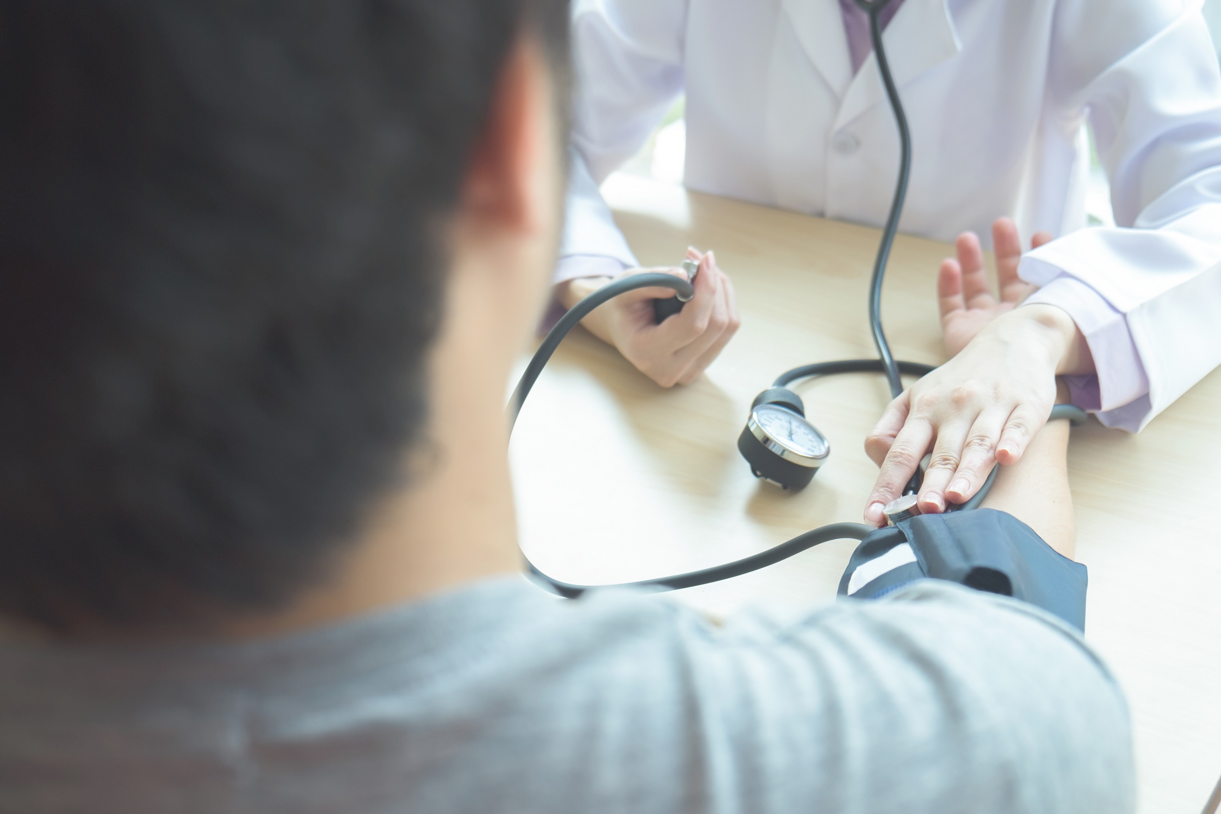 Doctor checking arterial blood pressure